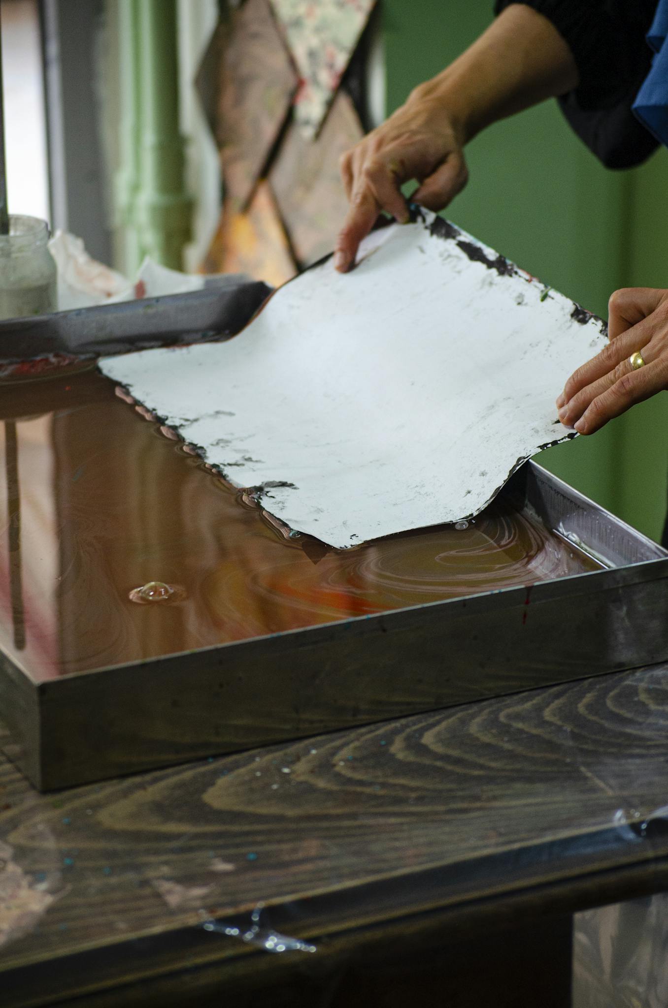 Close-up of artisan hands crafting handmade paper, showcasing creativity and artistry.